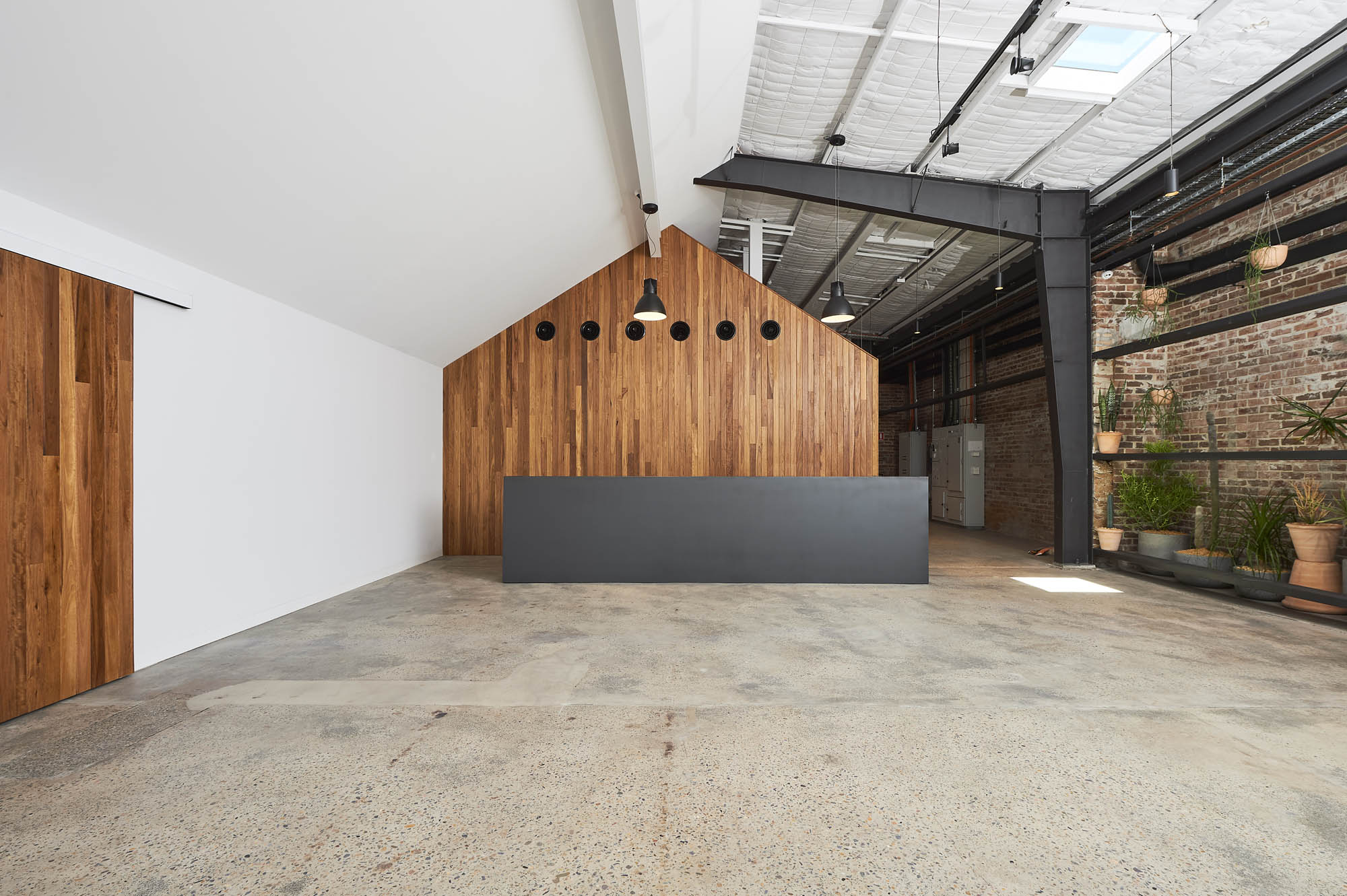 baker street studio sydney construction fitout reception timber steelwork exposed beams bricks concrete sliding door 