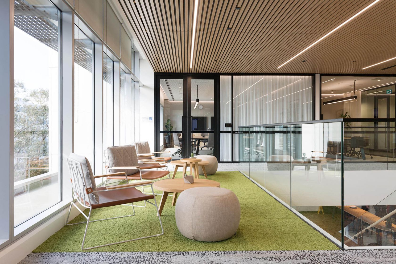 suez office with timber ceiling slats and chairs with foot stool