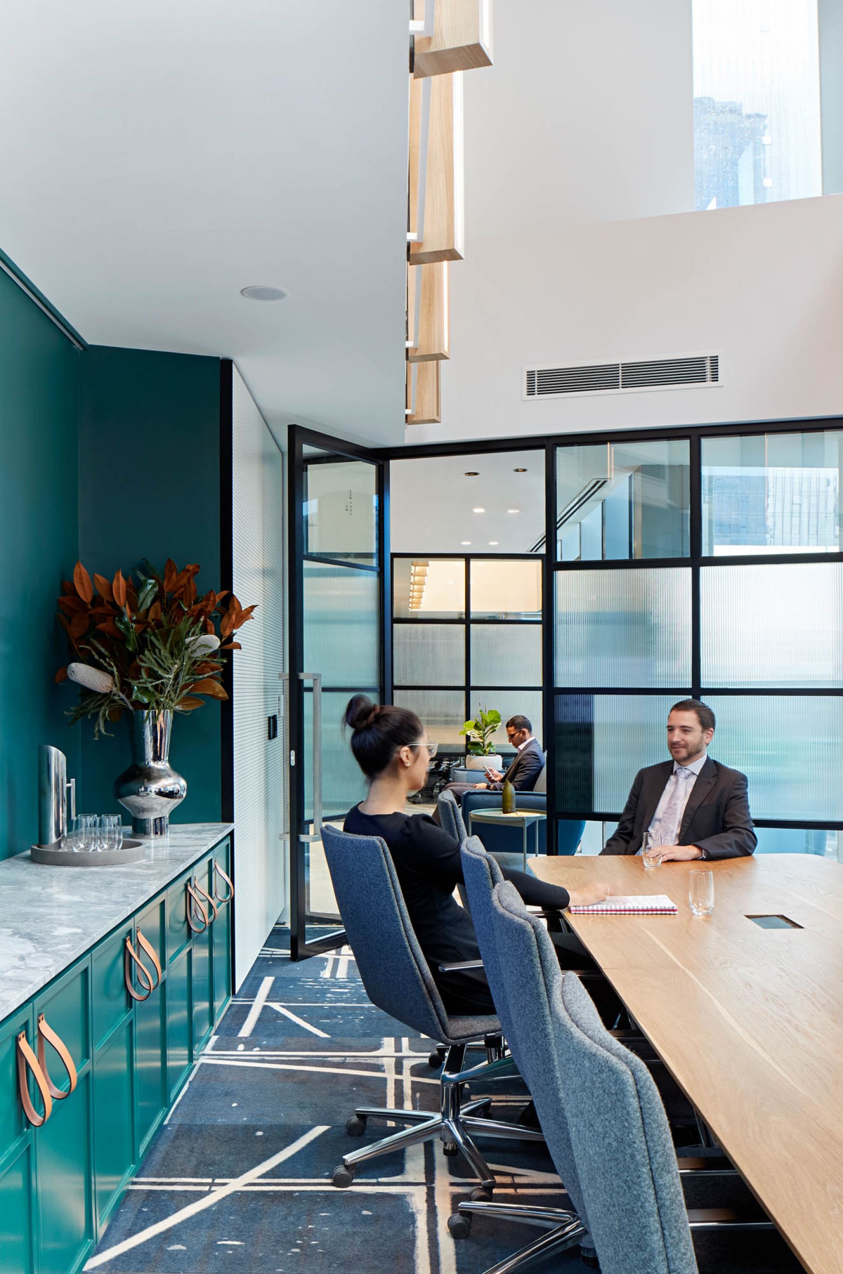 bank of melbourne office meeting room with green cabinets and gold strap handles