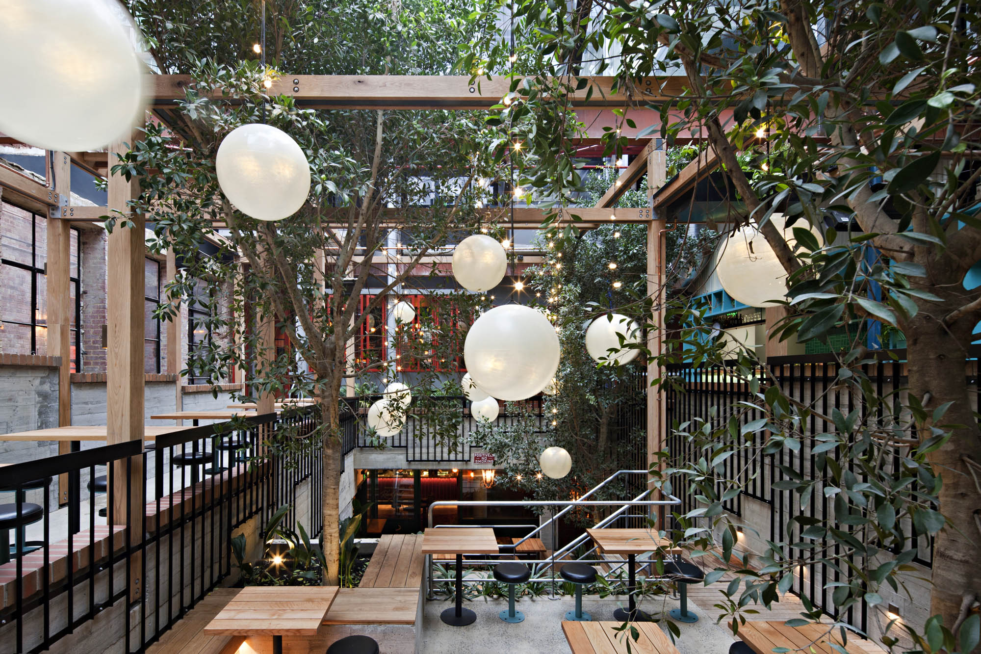 garden state hotel melbourne fitout alfresco dining outdoor pendant lighting trees stairs