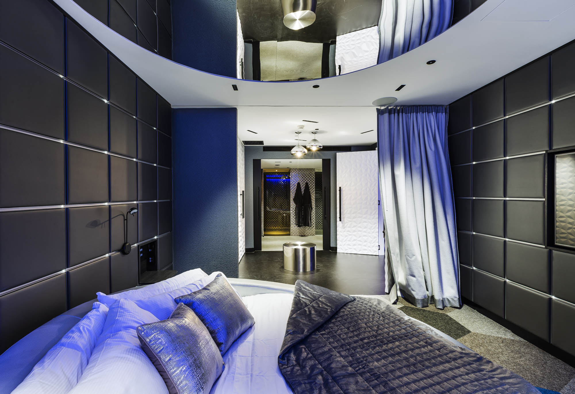 studios at the star sydney hotels design and construct nsw cyberpunk room grey walls blue lighting round bed metallic