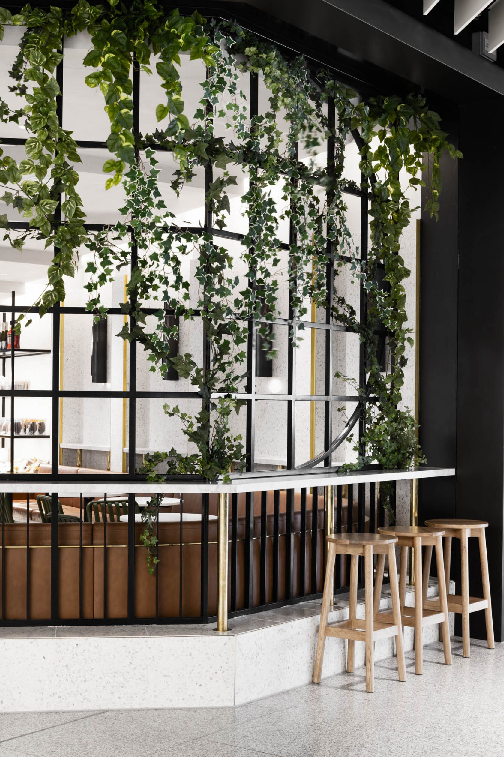 brunetti t2 hospitality interior fitout vic melbourne airport greenery stools table exterior