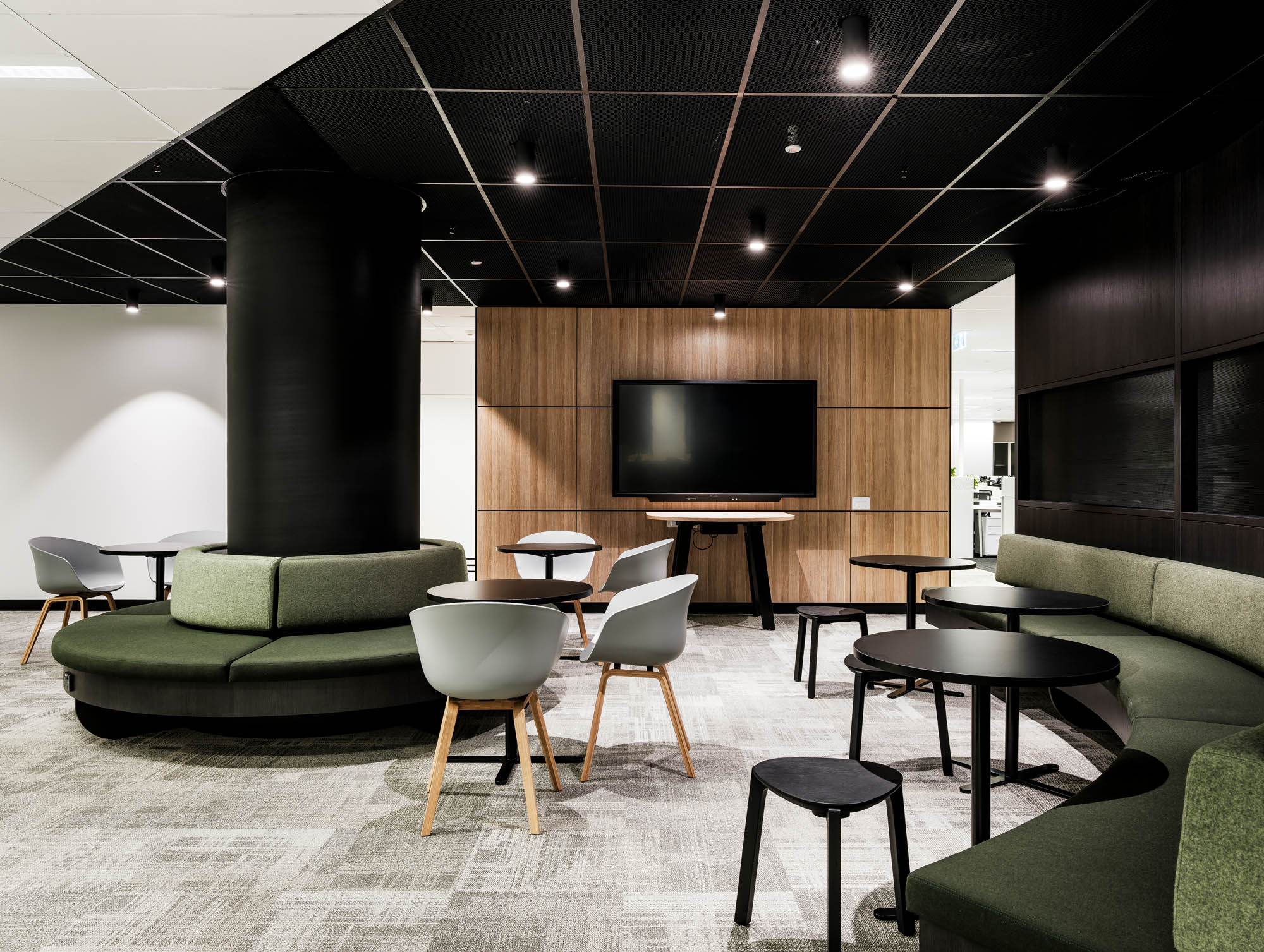 broadspectrum office with green couches, timber feature wall and TV