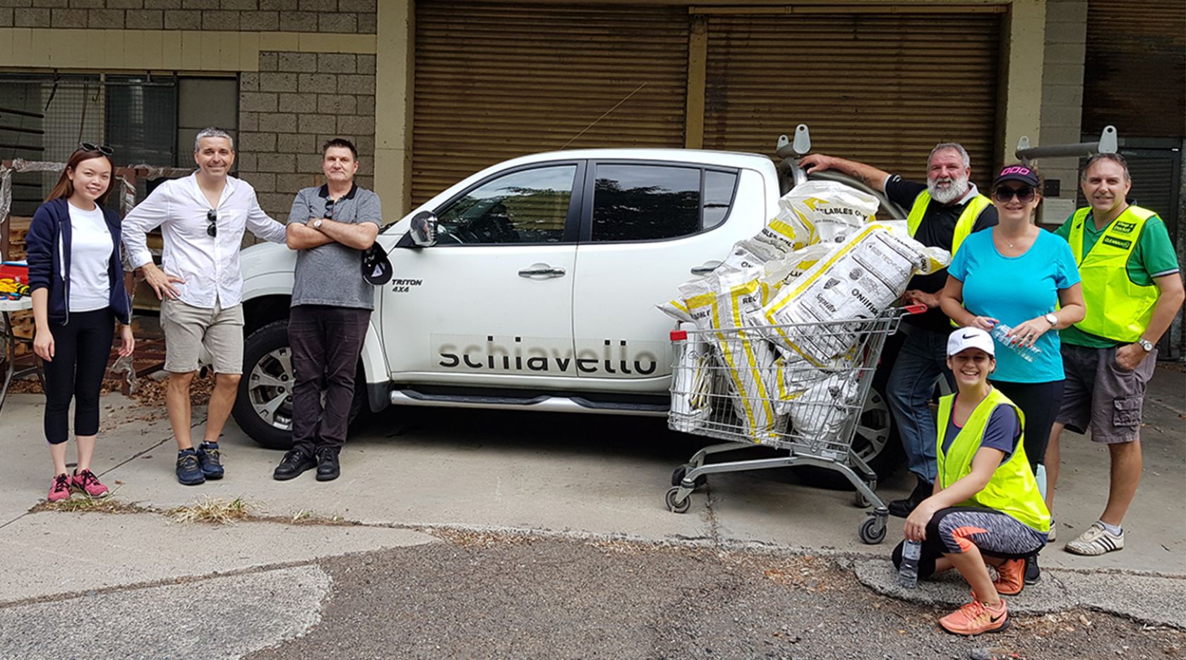 schiavello queensland employees stand in front of white company vehicle for clean up australia day