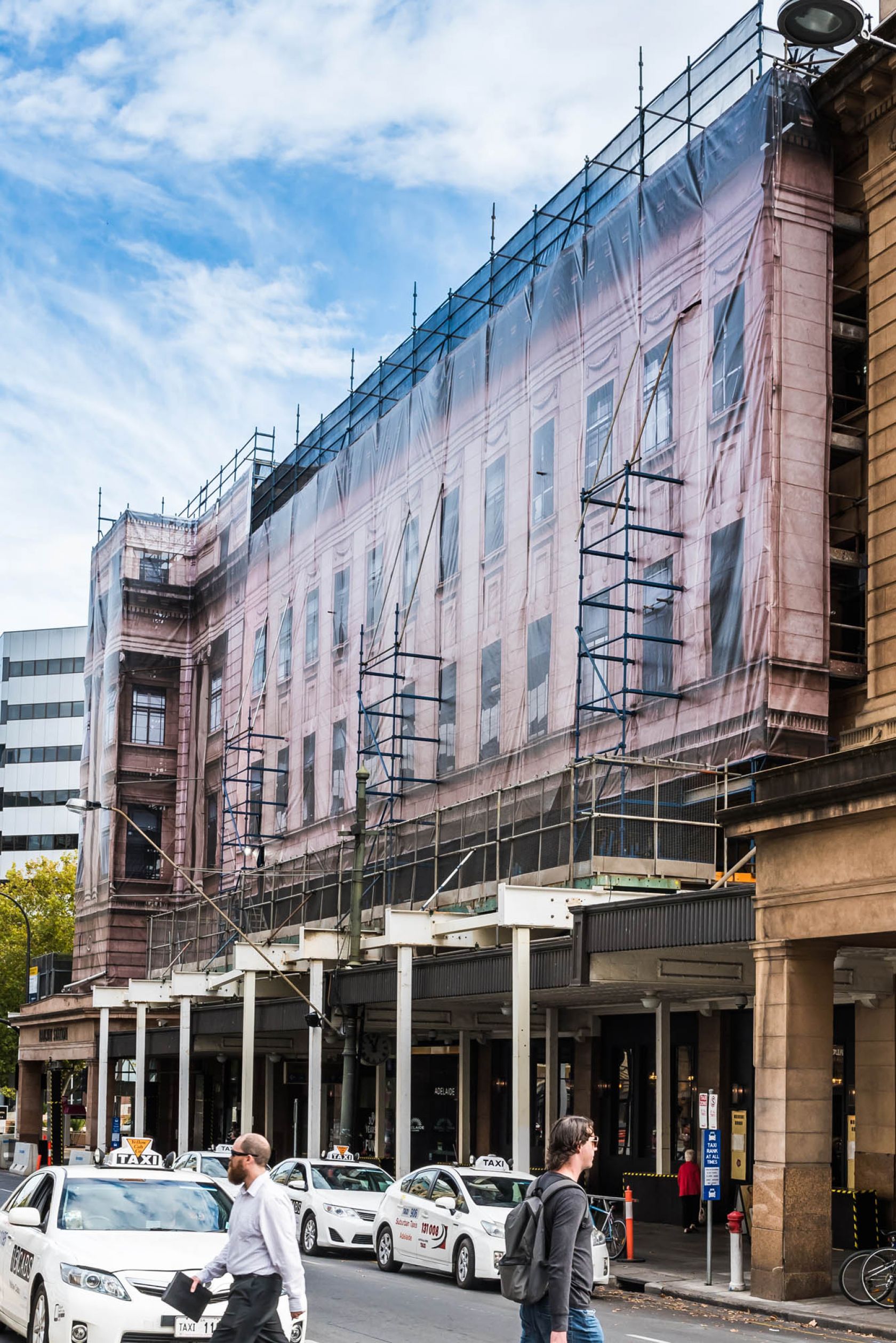 People leaving Adelaide Railway Station during its heritage facade upgrade