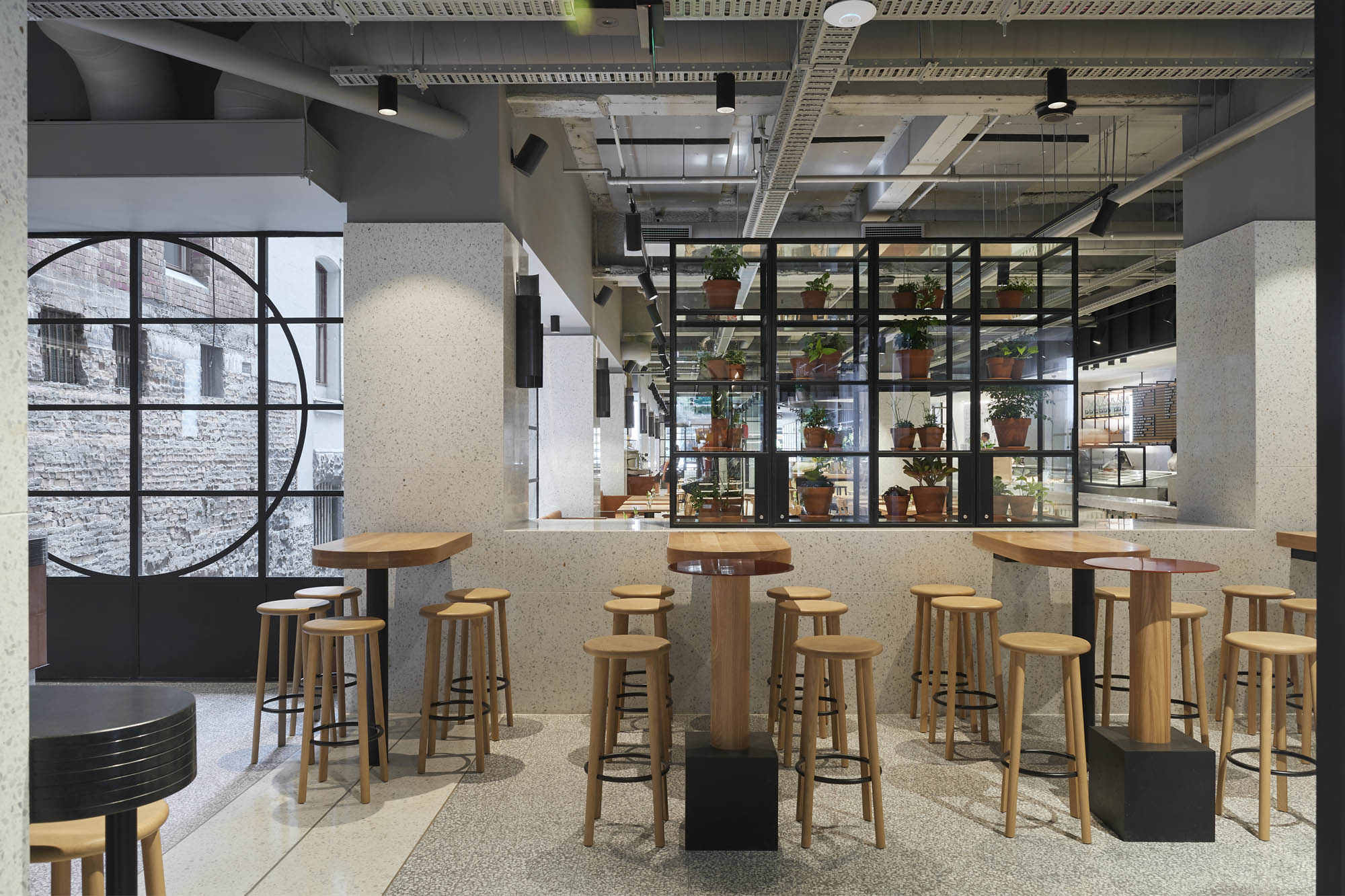 brunetti cafe emporium flinders lane hospitality demolition interior construction vic high tables high stools wood vertical  garden plants windows