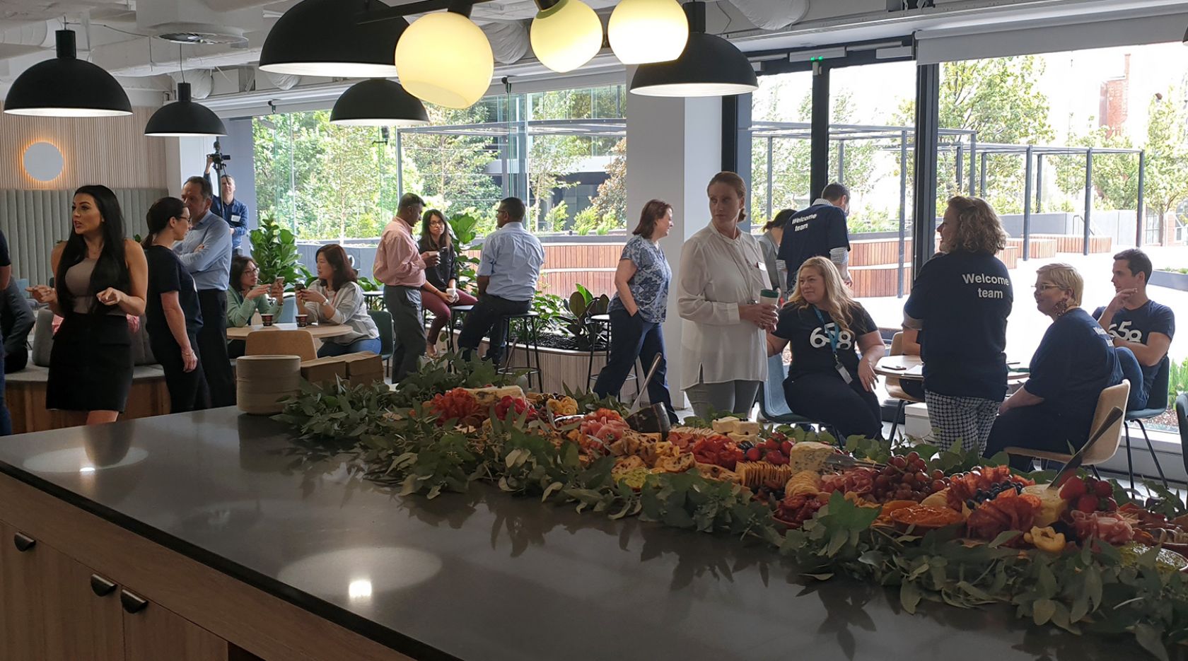 7-eleven employees gather around welcome food grazing platter