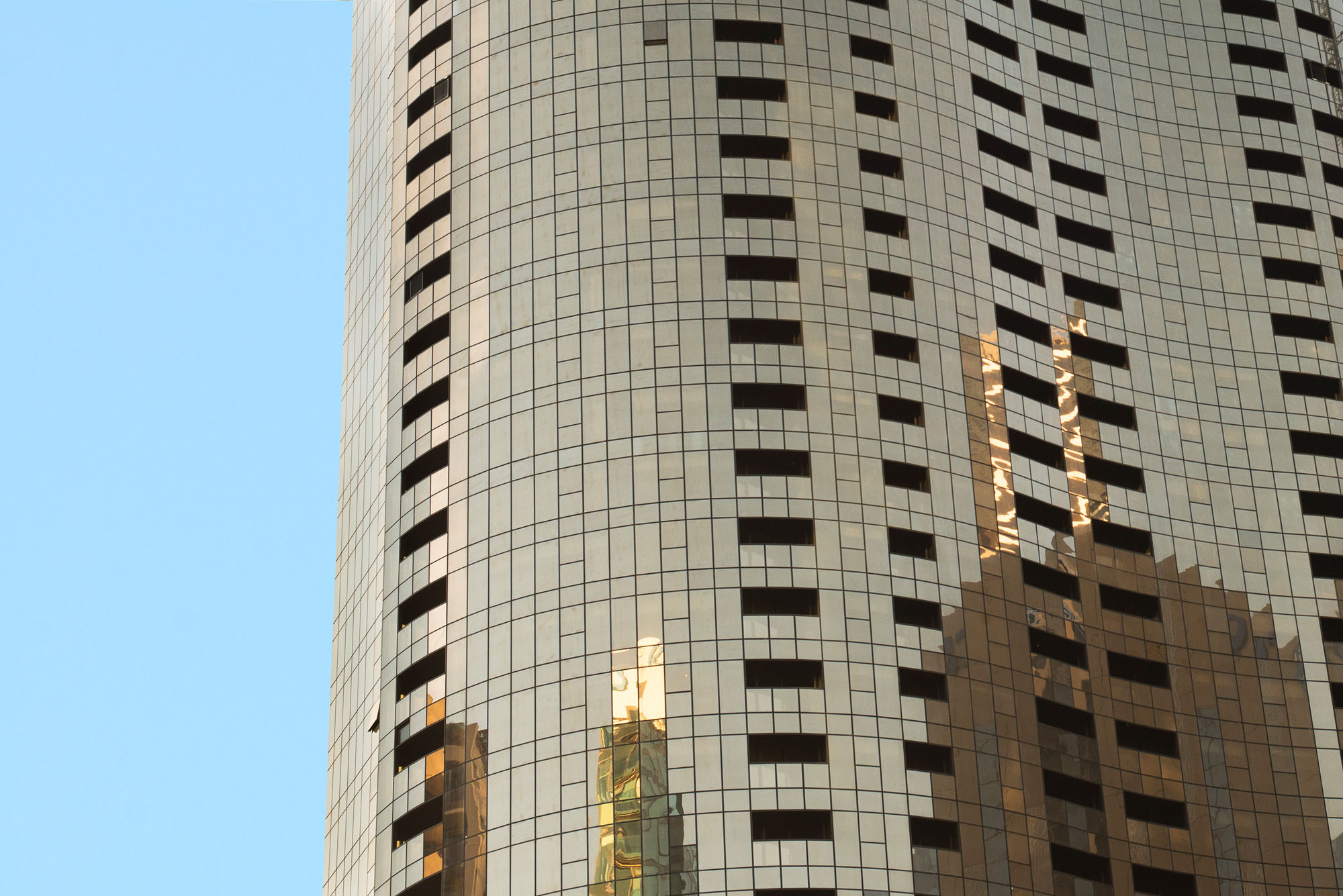 prima tower building exterior facade closeup gold reflection