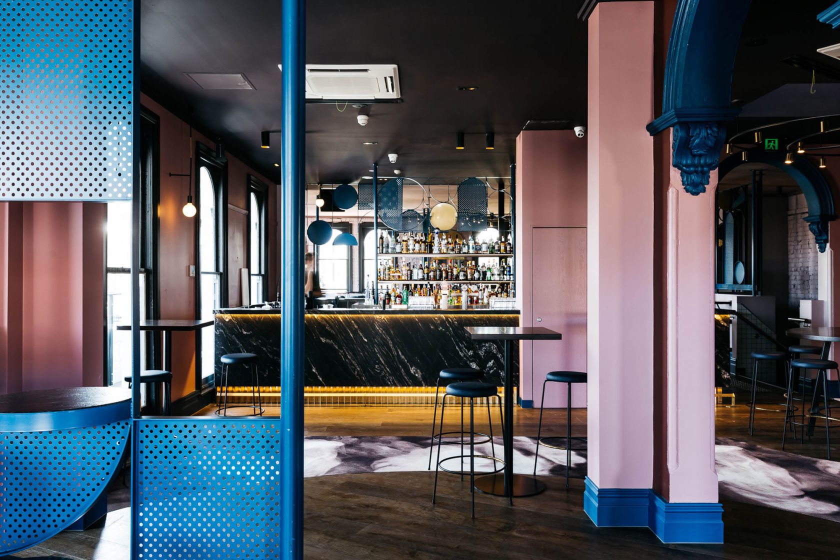 village belle hotel hospitality construction vic st kilda barkly st doulton lounge pink lounge gold pendant lights casual cosy bar melbourne blue perforated metal marble bar