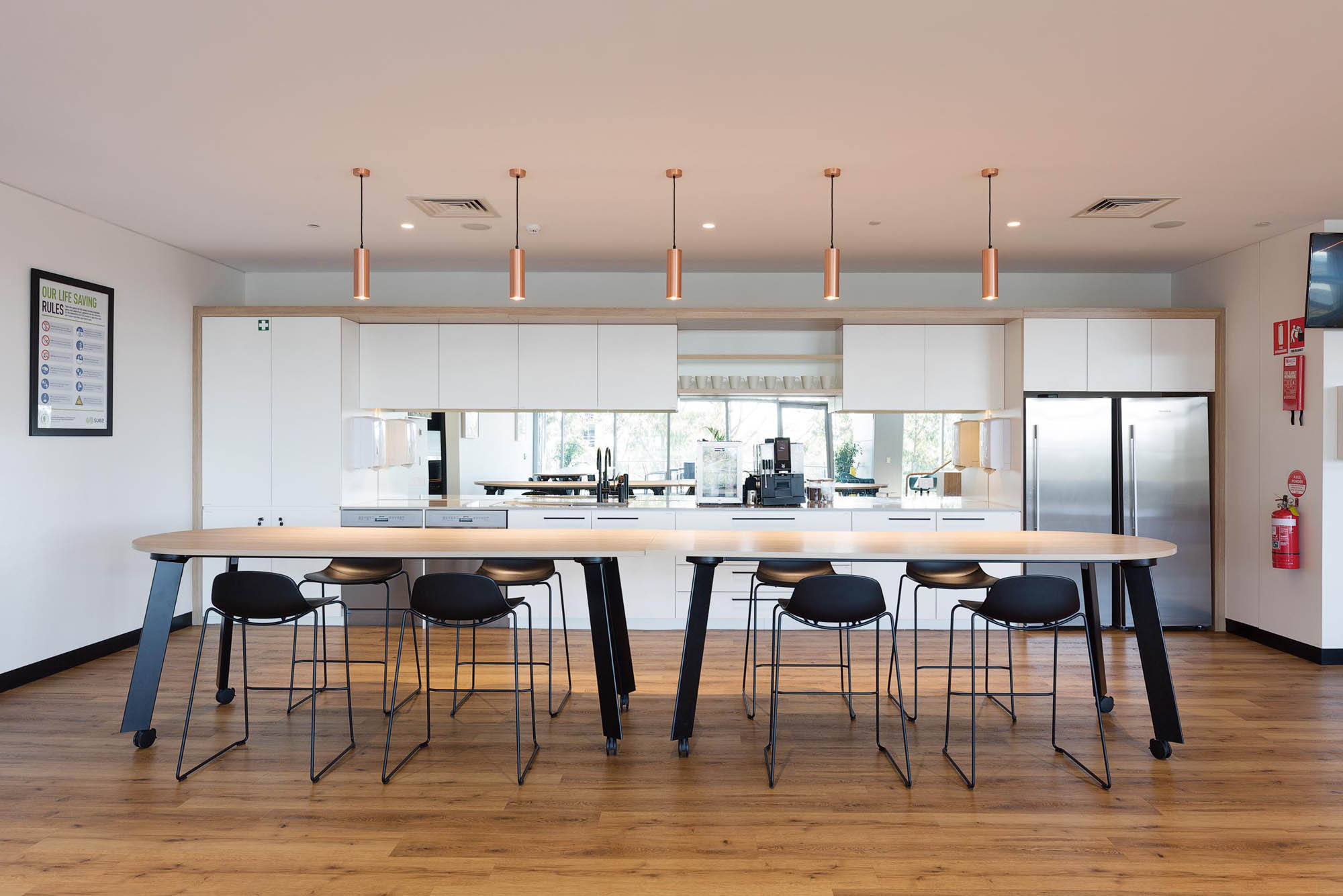 suez office kitchen hanging lights and timber table