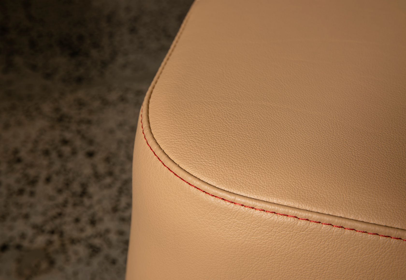 Karo Ottoman leather and red stitch detail