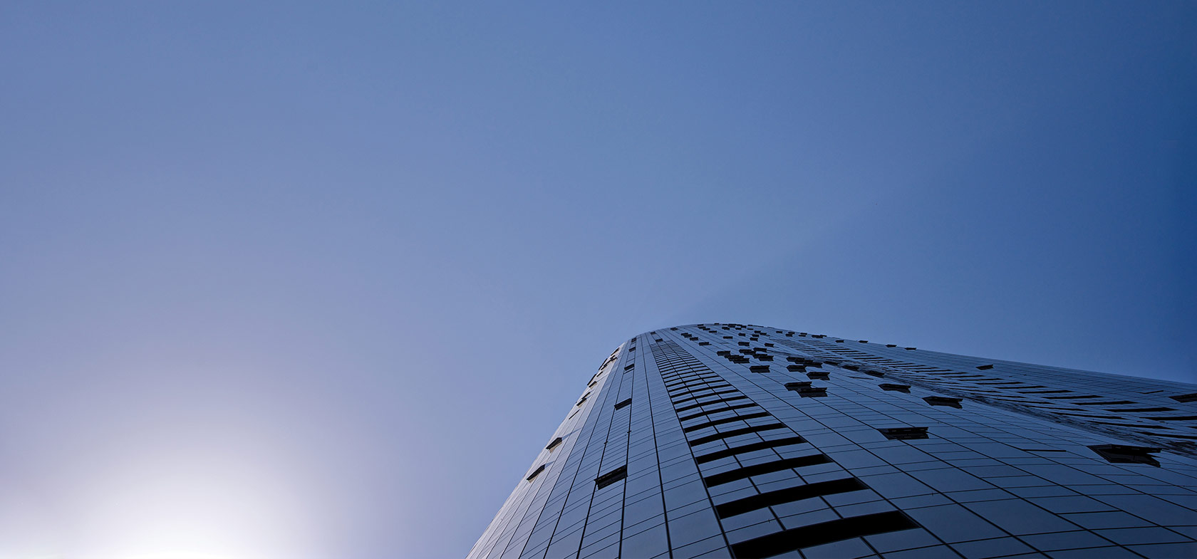 looking up at building in blue sky