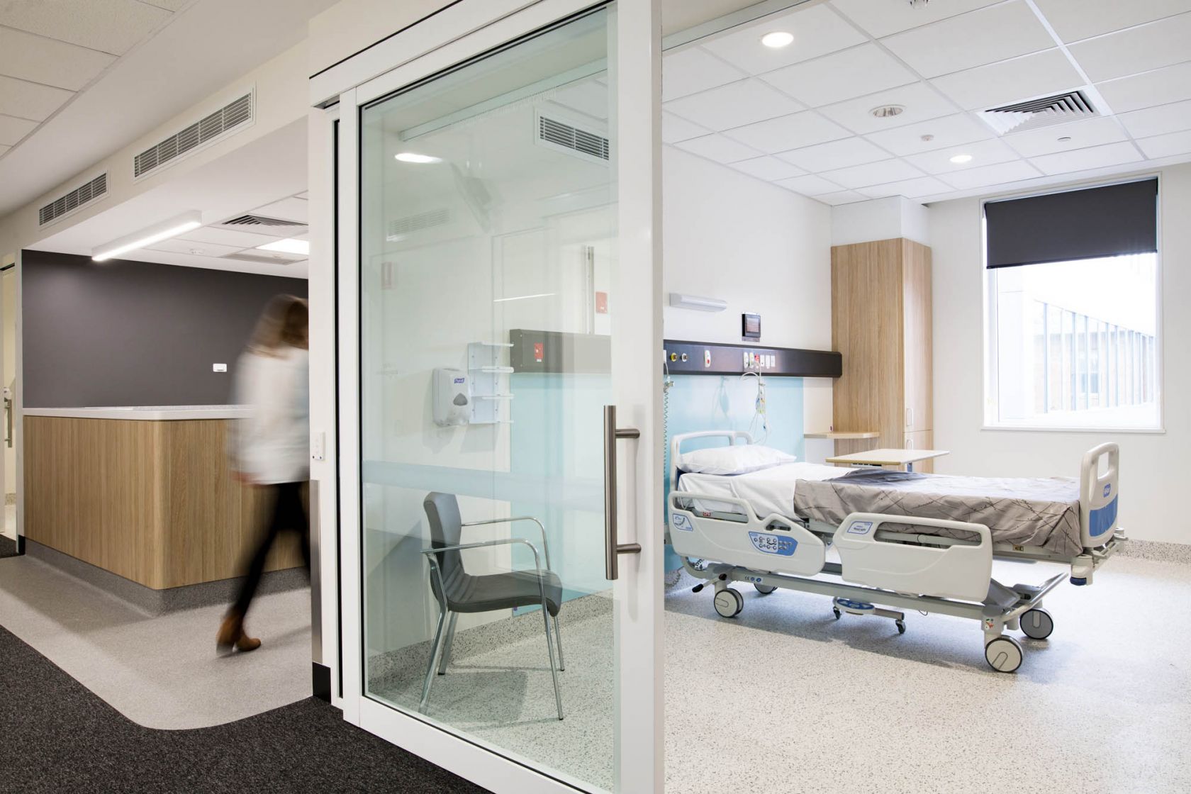 ashford hospital interior woman walking into empty room with medical equipment