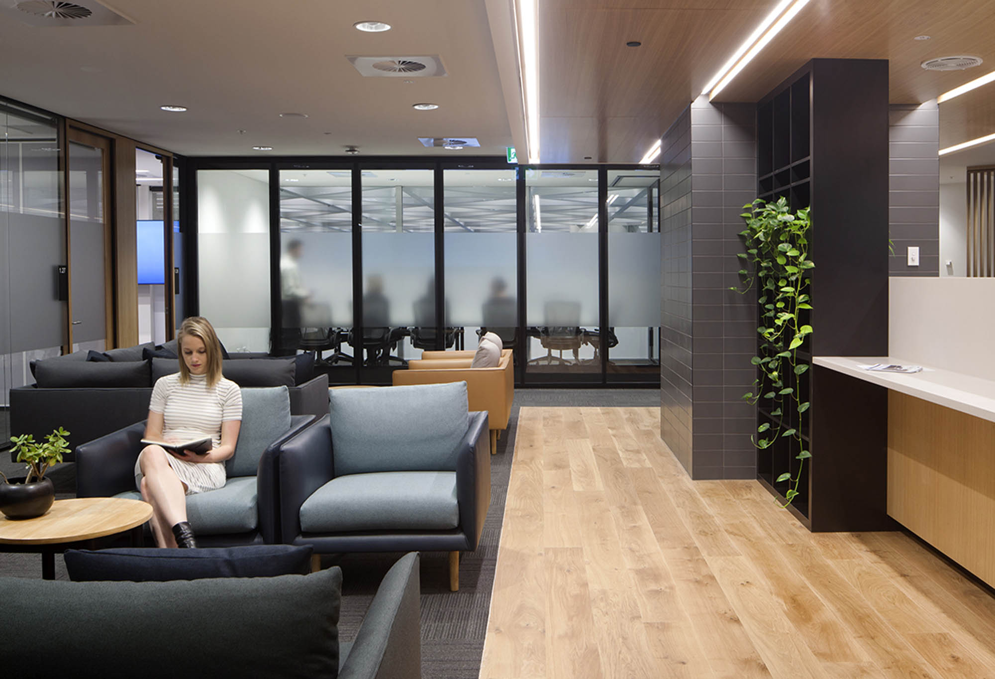 carousel unisuper melbourne workplace office fitout waiting timber floorboard wood linear lighting greenery reception