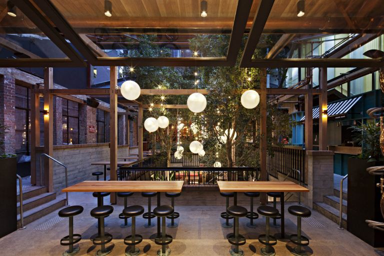 garden state hotel melbourne fitout outdoor bar trees timber lights