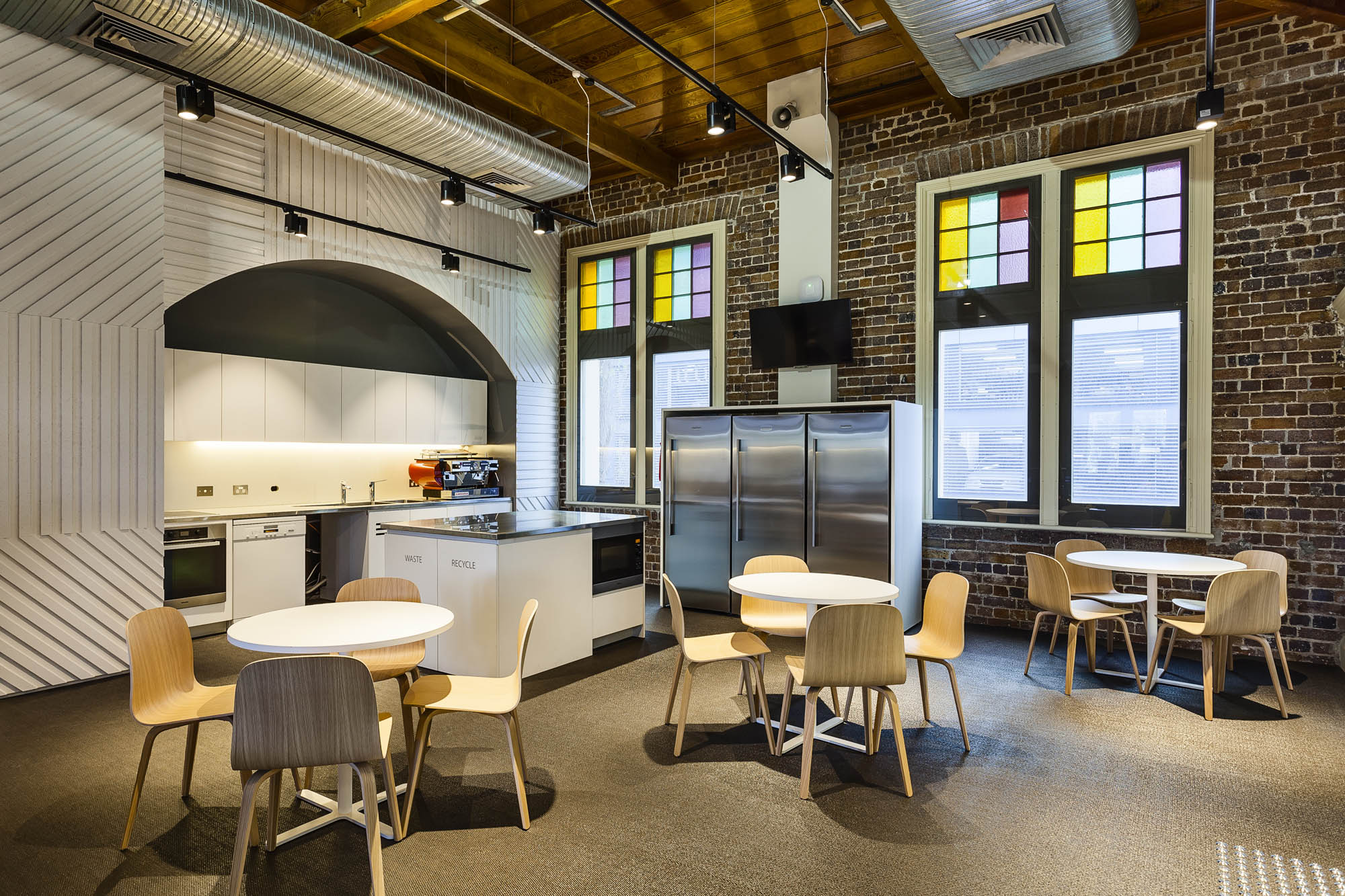 wotif sydney fitout heritage kitchen stained glass exposed ceiling ducts 