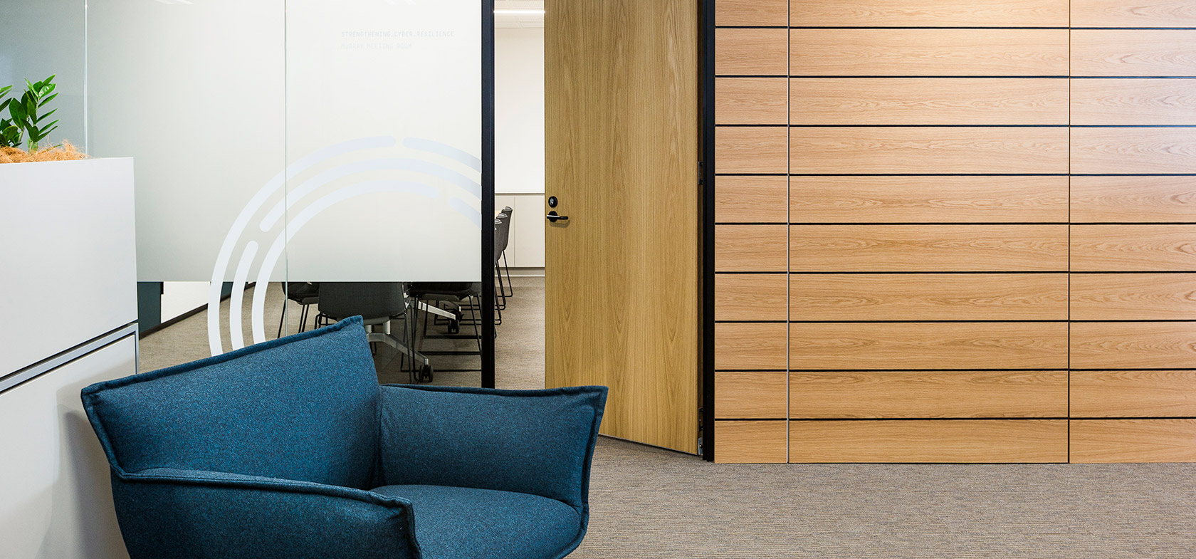 Dark blue single couch and timber wall office meeting room