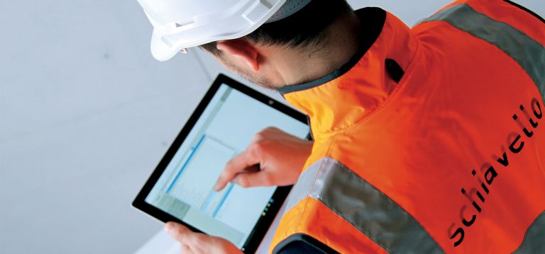Schiavello male employee holding tablet managing construction defects